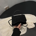 Minimalist black matte crossbody bag with elegant wavy flap and top handle design - Black
