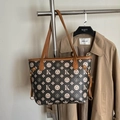 Classic dark brown patterned tote bag with tan leather trim on a metal hanger - Dark Coffee
