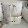 Minimalist off-white faux leather tote bag with buckle detail and long shoulder straps - White