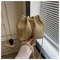 Detail of woven bucket bag featuring herringbone pattern, gold chain and pearl drawstrings - Woven Khaki