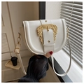 Close-up of elegant white saddle bag featuring a large vintage gold embossed buckle and strap - White