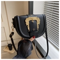 Close-up of black leather saddle bag with ornate gold baroque buckle and slim strap - Black
