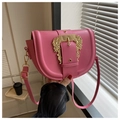 Detail of peach pink saddle bag with gold baroque buckle and adjustable leather strap - Pink