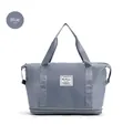 Blue travel duffel bag with bottom shoe compartment and double handles in a macro detail view - Blue