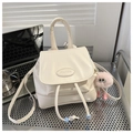 Chic off-white mini backpack and handbag with cute plush monster charm and PAUTOR logo - White With Pendant