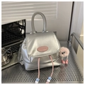 Silver metallic mini backpack with pink brand tag and plush keychain accessory - Silver With Pendant