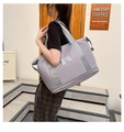 Detail view of purple travel tote bag with extended zipper base and gray shoulder strap - Gray
