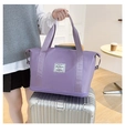 Purple travel bag with luggage strap and expansion layer shown on a suitcase handle - Taro Purple