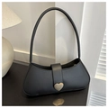 Detailed close-up of a black minimalist baguette bag with a heart-shaped metal lock - Black