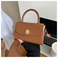 Detailed view of caramel PU leather bag with golden radial lock and fine shoulder strap - Tan