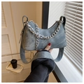 Close-up of blue denim crescent bag with silver chunky chain and wide shoulder strap - Vintage Blue