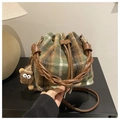 Checkered drawstring bucket bag in forest green and brown with a fuzzy monster charm - Green with Pendant