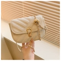Quilted cream crossbody bag with adjustable gold ball chain and stylish V-pattern - Off White