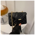 Detail of black PU leather crossbody bag with V-quilt pattern and gold chain strap - Black