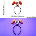 Detail showing dimensions of Halloween winged eyeball headband with glowing purple effect - Bat Wings and Eyeballs Style