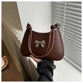 Detail of a dark brown crescent bag featuring a silver metal bow and knotted strap - Dark Brown