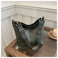 Detail of dark green bucket bag with bohemian embroidered strap and gold hardware - Green