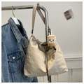Chic beige tote bucket bag with drawstring and cute coffee plush charm on blue denim - Khaki With Rabbit Pendant