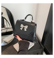 Fashionable black faux leather small square bag with silver metal bow and top handle - Black