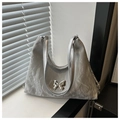 Detailed macro view of silver metallic bucket bag with butterfly buckle and pleated texture - Gray