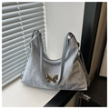 Detail of light blue pleated bucket bag with silver butterfly charm and chain strap - Blue