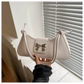 Elegante borsa a spalla avorio con chiusura a fiocco argento e tracolla con nodi - Bianco