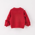 Dettaglio del maglione rosso lavorato a maglia per bambini con morbidi pompon sulle maniche - Maglione Rosso Brillante / 90cm