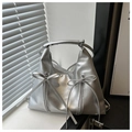 Metallic silver bucket bag with double bow details and vertical zippers in natural light - Silver