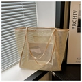 Detailed shot of beige mesh tote bag with flat handles in a minimalist natural light setting - Khaki