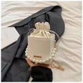 Creamy white drawstring bucket bag with elegant pearl handle and gold chain strap - White