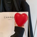 Detail of red heart-shaped hard shell clutch bag with gold metal chain strap - Red