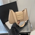Elegant beige PU leather hobo bag with gold metal buckle flap shown in hand - Khaki
