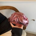 Detail of metallic pink cloud bag showing soft pleated texture and shiny finish - Pink