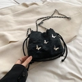 Minimalist black drawstring bucket bag with silver butterfly charms and chain strap - Black