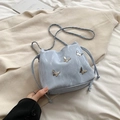 Light blue bucket bag with silver butterfly charms and chain strap in soft textures - Blue