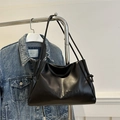 Minimalist black glossy leather underarm bag with drawstring sides and embossed text detail - Black