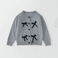 Detail of grey knitted girls cardigan featuring black 3D bows and round buttons - 90cm / Tops / Gray