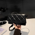 Chic black quilted crossbody bag with unique knot rope strap and gold metal hardware - Black