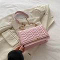 Pink quilted crossbody bag with V-pattern leather and gold chain strap in elegant setting - Pink