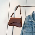 Brown minimalist shoulder bag with wavy flap design and knotted strap detail - Brown