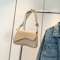 Elegant cream-colored shoulder bag with a unique asymmetrical wavy flap and knotted strap - Khaki