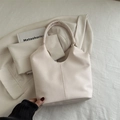 Minimalist cream beige hobo bucket bag in pebbled leather with seamless shoulder strap - Off White