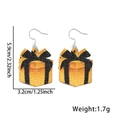 Neujahrs-Ohrhänger als orangefarbene Glitzer-Geschenkbox mit schwarzer Schleife - Neujahr Ohrringe / Schwarzgoldener Geschenkkarton-Stil
