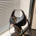 Minimalist black crescent hobo bag in glossy leather with adjustable strap and charm - Black