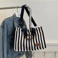 Navy and white striped canvas tote bag with brown leather handles and adjustable shoulder strap - Blue
