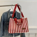 Red and white striped canvas tote bag with wide red straps and fashion leather label - Red