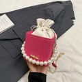 Rose pink cube box bag with pearl handle, woven texture, and white drawstring liner - Pink