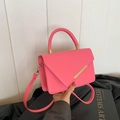 Elegant rose red crossbody bag with pebble grain leather and golden metal clasp - Pink