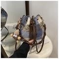 Detail of plush plaid bucket bag featuring blue brown check pattern and drawstring - Blue (With Charm)