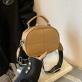 Minimalist camel litchi leather pillow bag with stylish wide black and white strap - Khaki